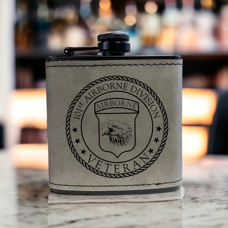 Gray leather wrapped black stainless steel 6oz Flask featuring the 101st Airborne Veteran logo