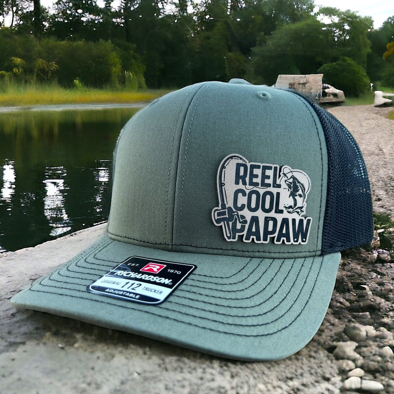 Richardson 112 Loden Green/Black trucker hat featuring the Reel Cool Papaw design, perfect for the grandfather that loves fishing