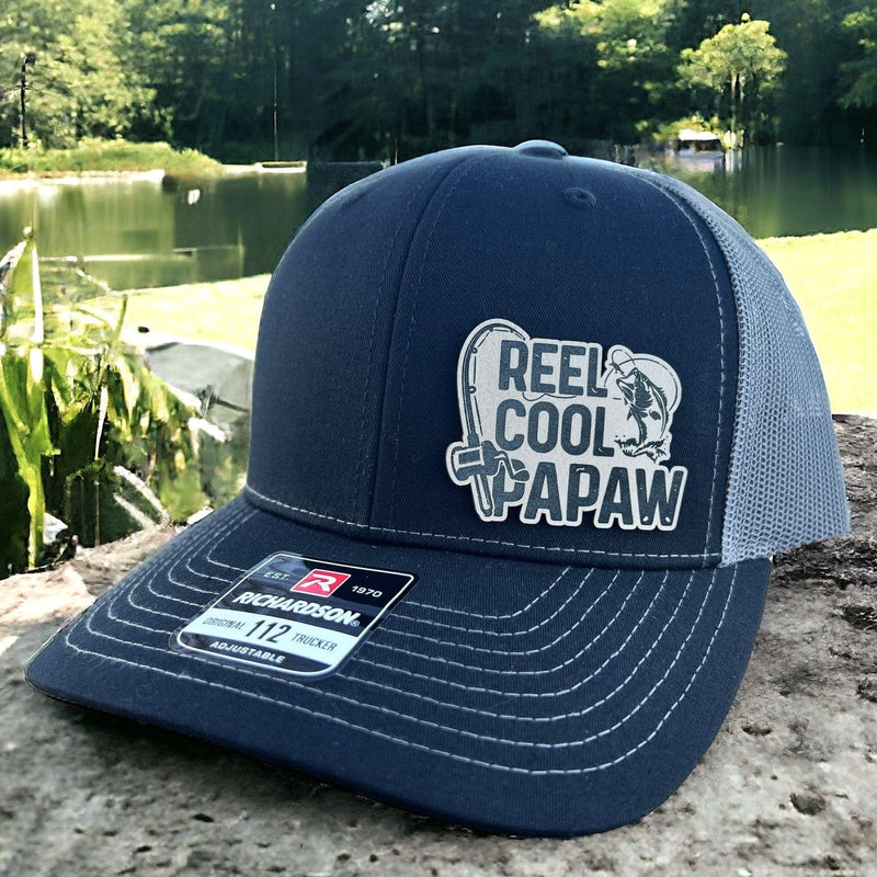 Richardson 112 Loden Black on Gray mesh trucker hat featuring the Reel Cool Papaw design, perfect for the grandfather that loves fishing